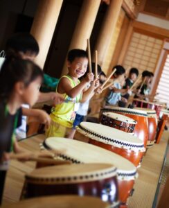 Honeyview_group-of-children-playing-the-drums-in-a-temple-a-2022-03-04-02-07-22-utc